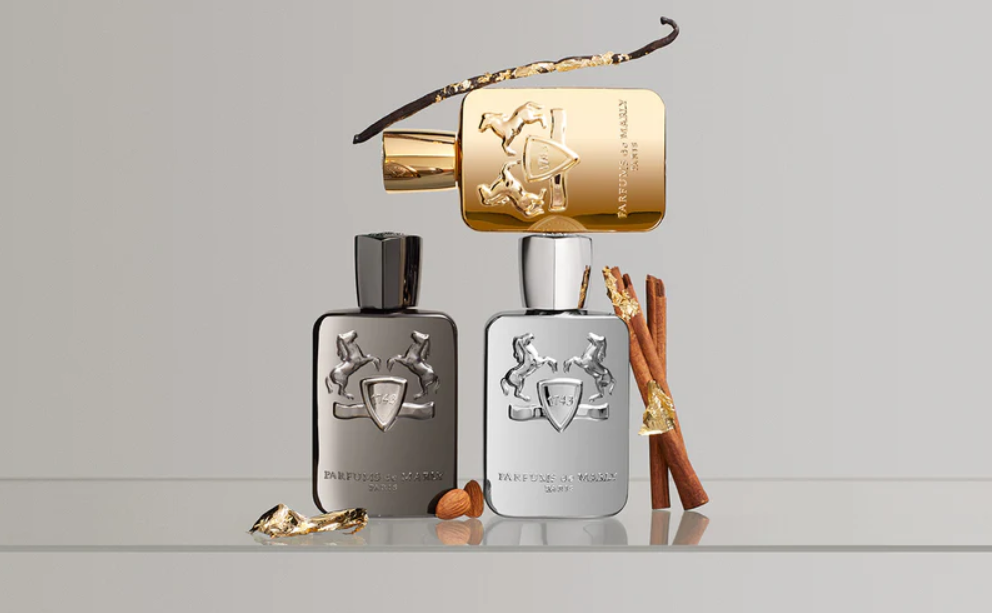 Three perfume bottles of parfums de marly on a light gray background